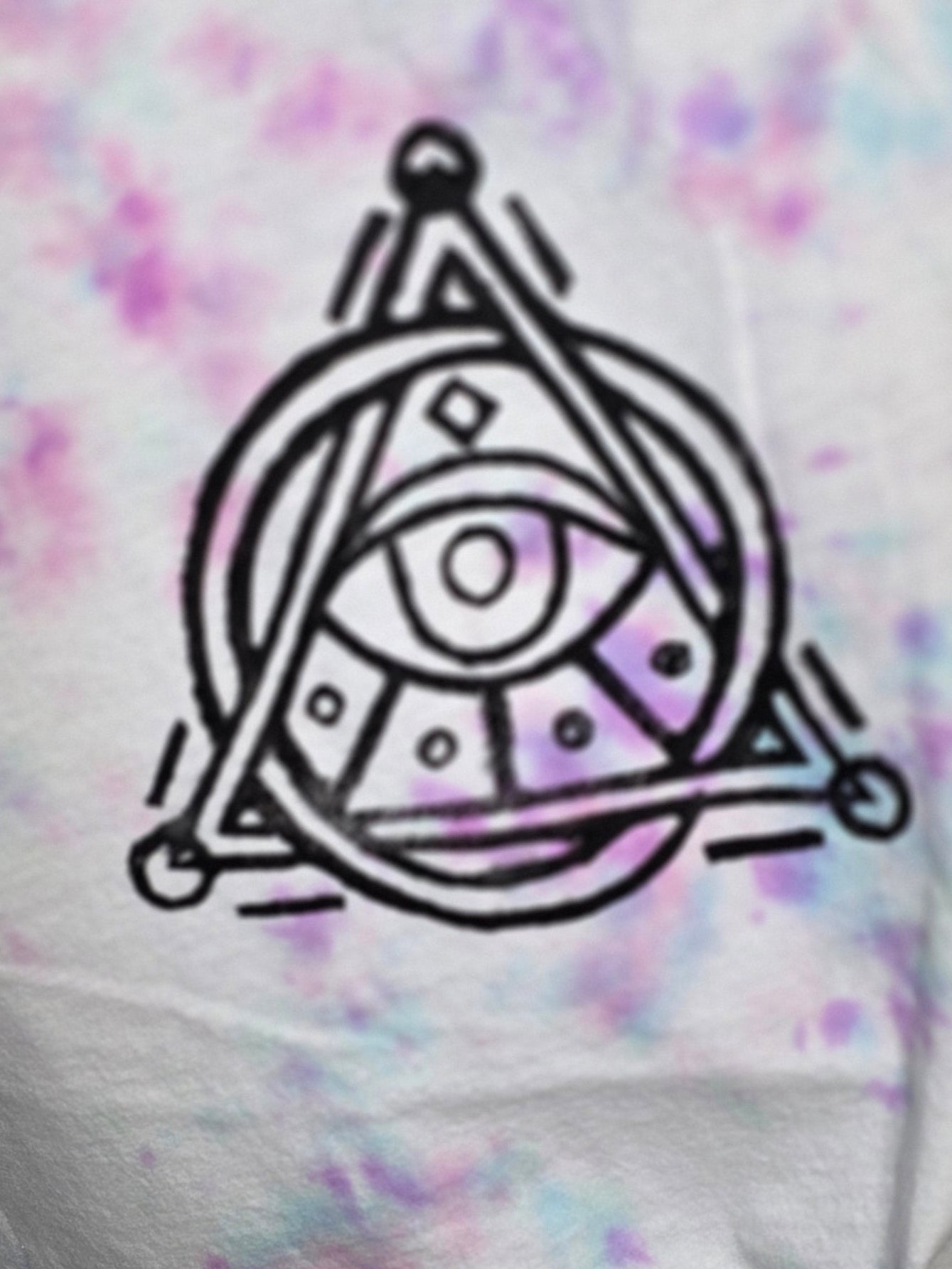 Black geometric design on a tie-dye background