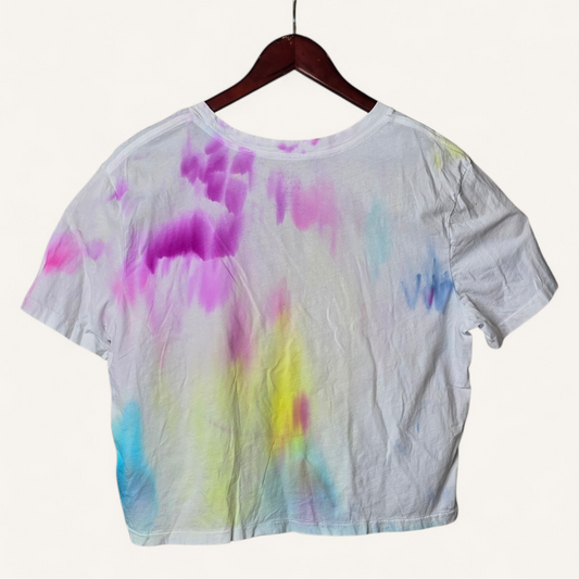 Tie-dye shirt on a hanger with a white background