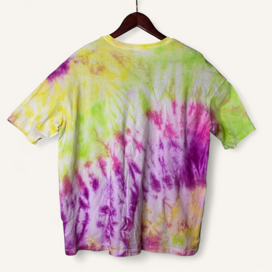 Colorful tie-dye t-shirt on a hanger against a white background