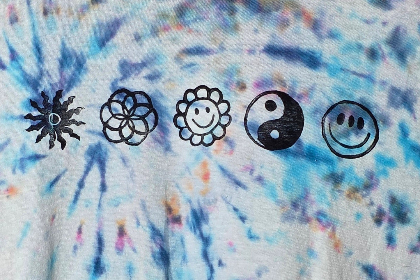 Set of five black symbols on a tie-dye background