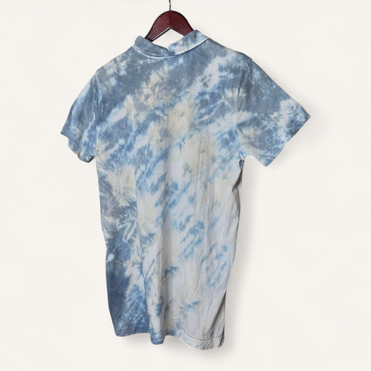Blue and white tie-dye shirt on a hanger against a white background
