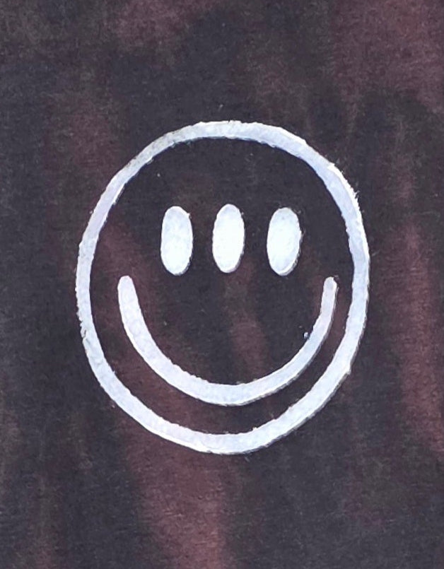 White smiley face symbol on a dark background