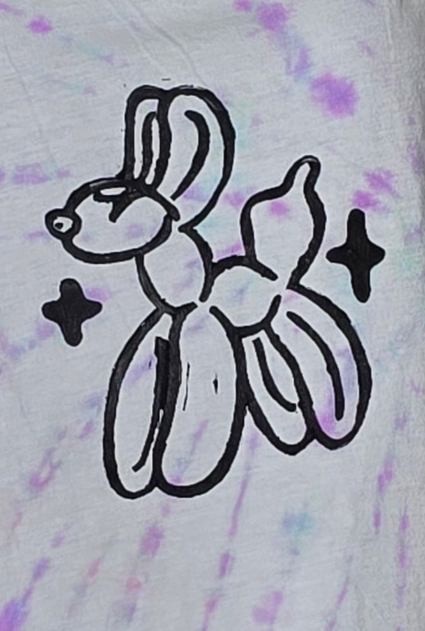 Black balloon animal design on a tie-dye background