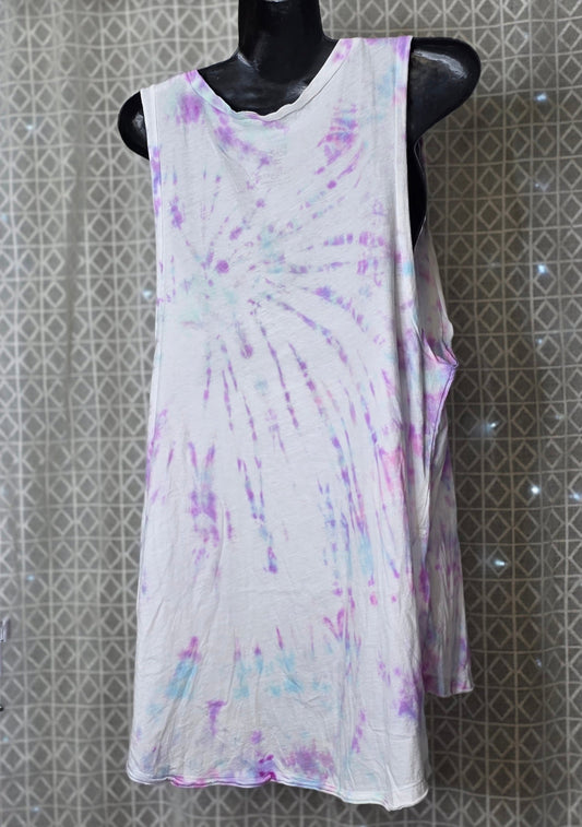 Tie-dye sleeveless dress on a mannequin against a patterned wall.
