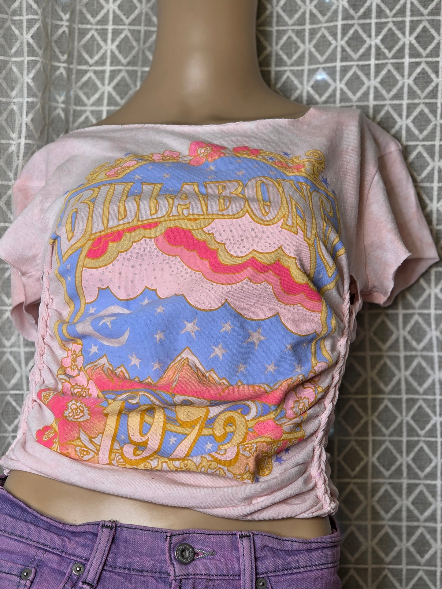 Mannequin wearing a colorful scarf with text on a tiled floor background