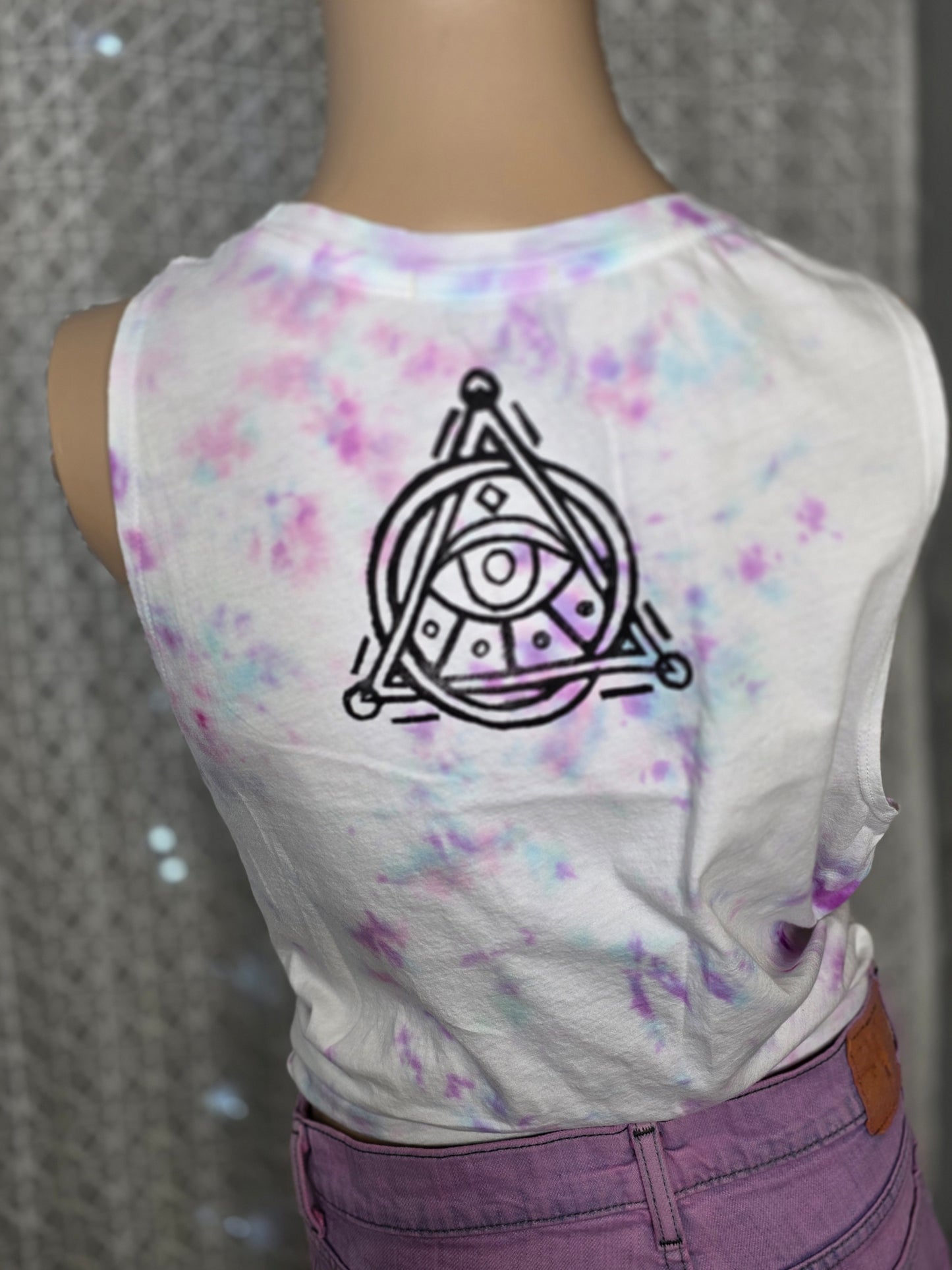 T-shirt with a black symbol design on a colorful watercolor background