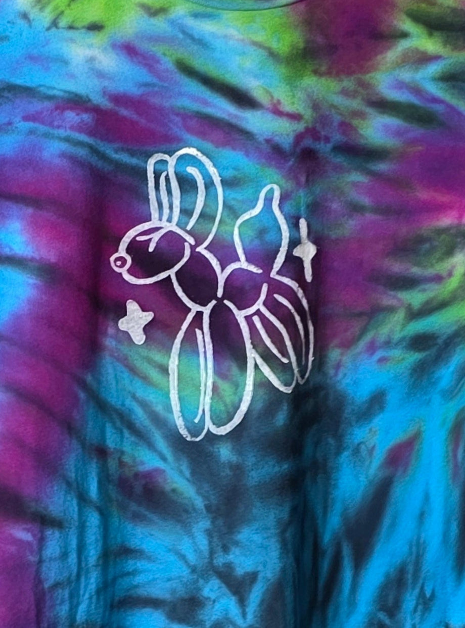 Tie-dye shirt with a white outline of a dog and star design on a colorful background