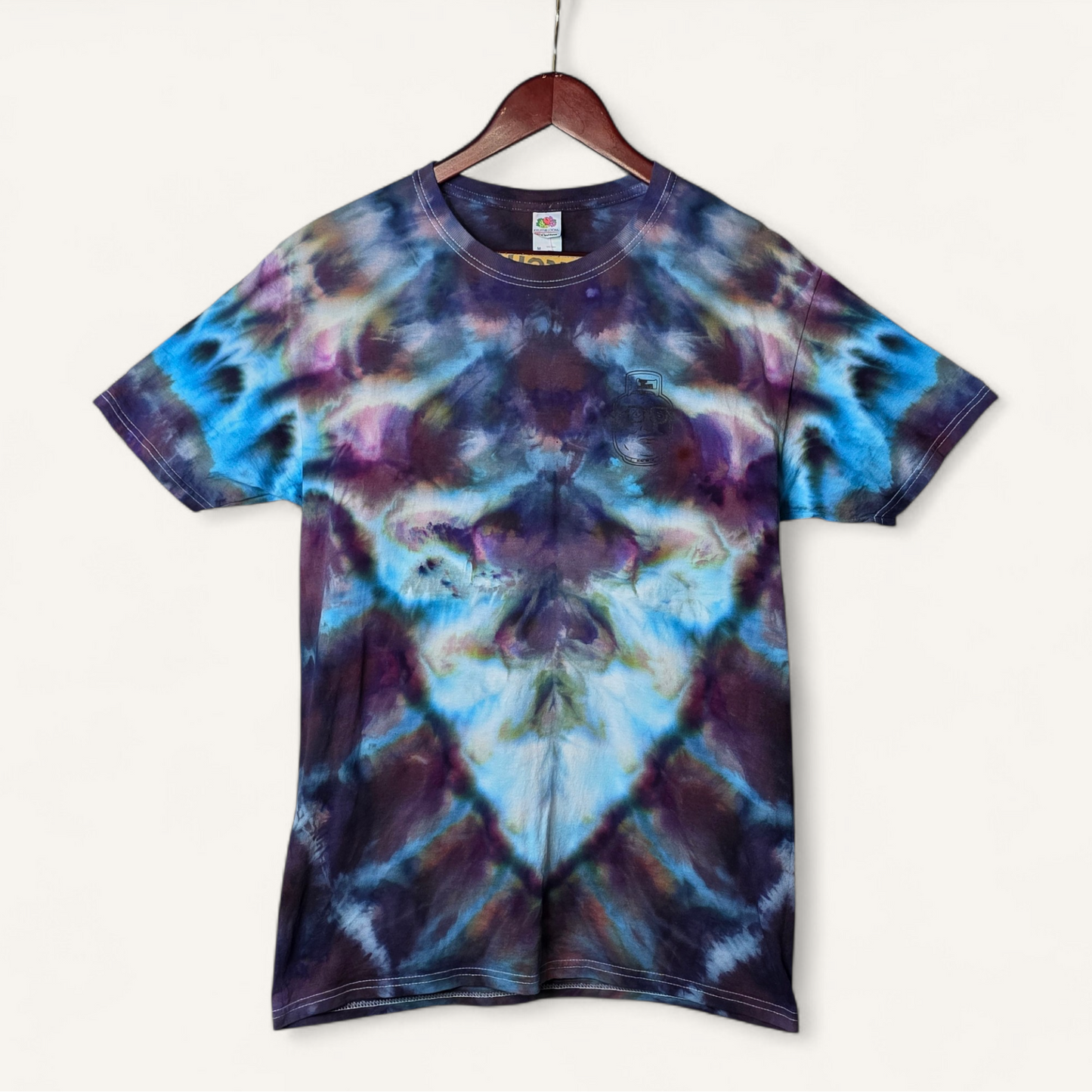 Tie-dye t-shirt on a hanger with a white background