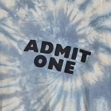 Tie-dye shirt with 'ADMIT ONE' text in black on a blue and white patterned background