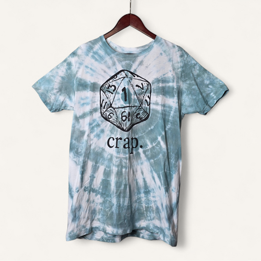 Tie-dye t-shirt with a die design and 'crap' text on a hanger against a white background