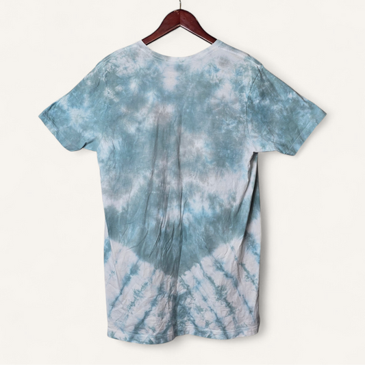 Blue and white tie-dye t-shirt on a hanger against a white background