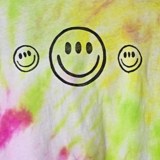 Three smiley faces on a tie-dye background