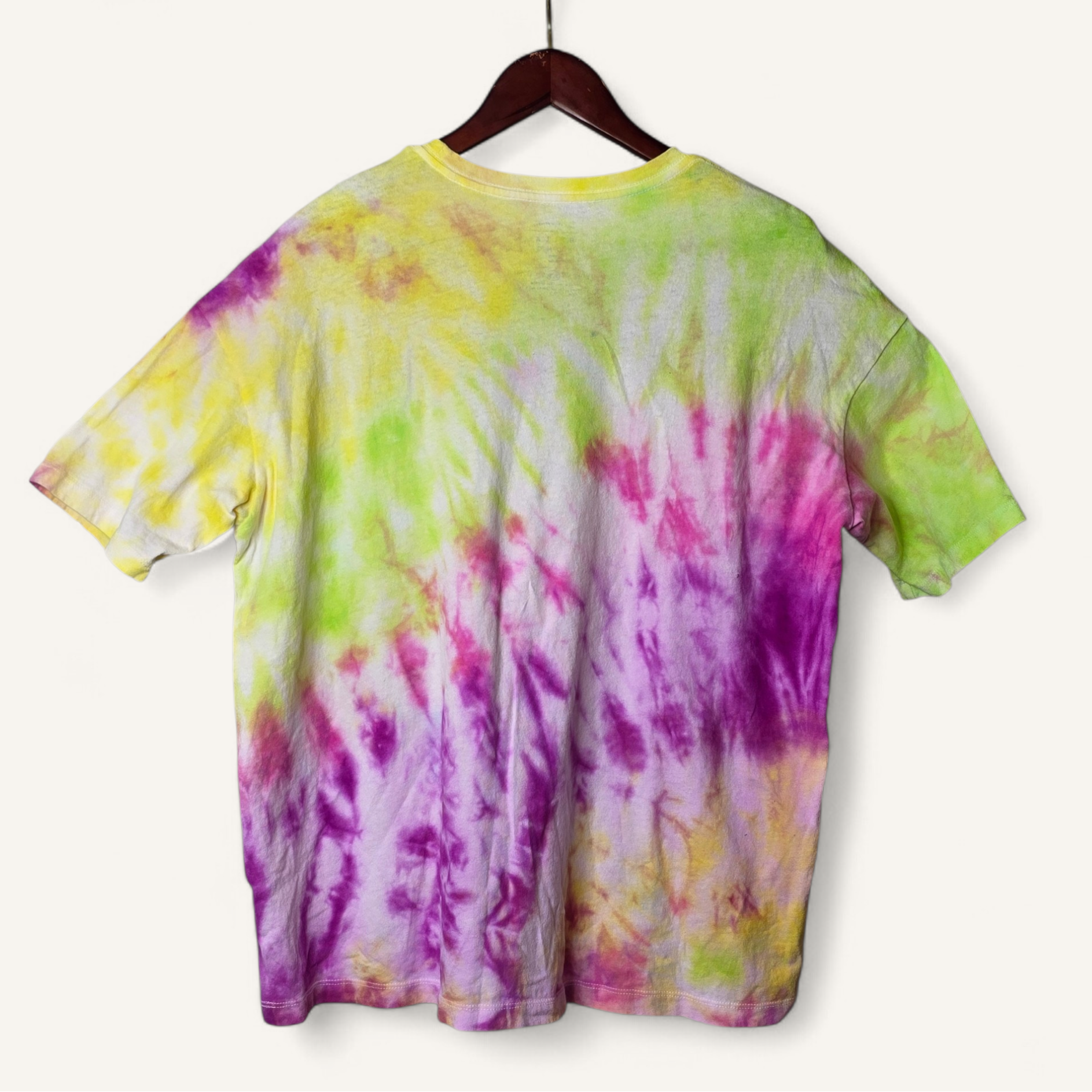 Colorful tie-dye t-shirt on a hanger against a white background
