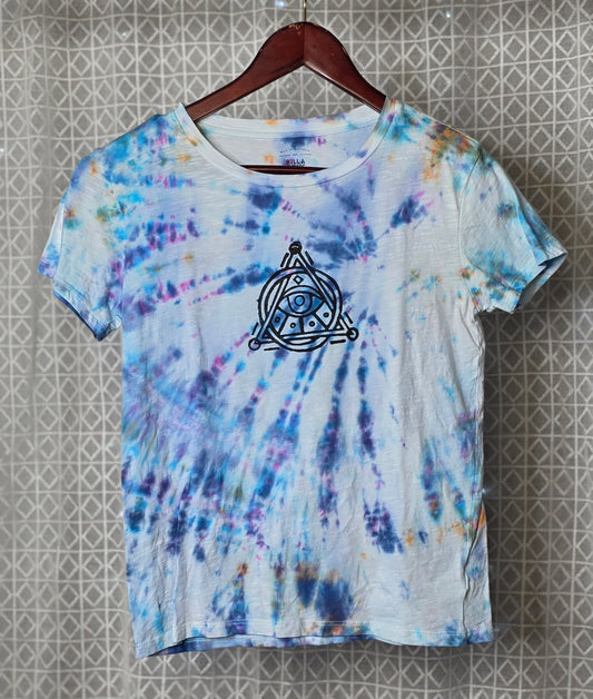 Tie-dye t-shirt with a black triangle on a textured wall background
