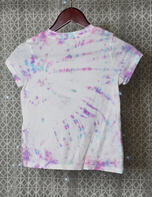 Short-sleeve shirt with colorful abstract pattern on a textured gray background