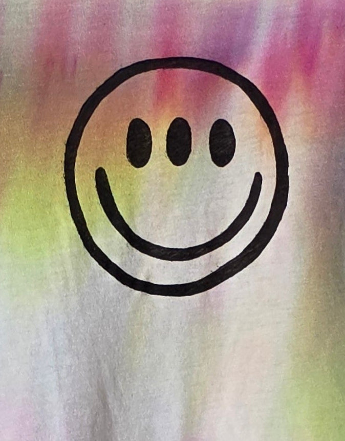 Black smiley face on a colorful tie-dye background