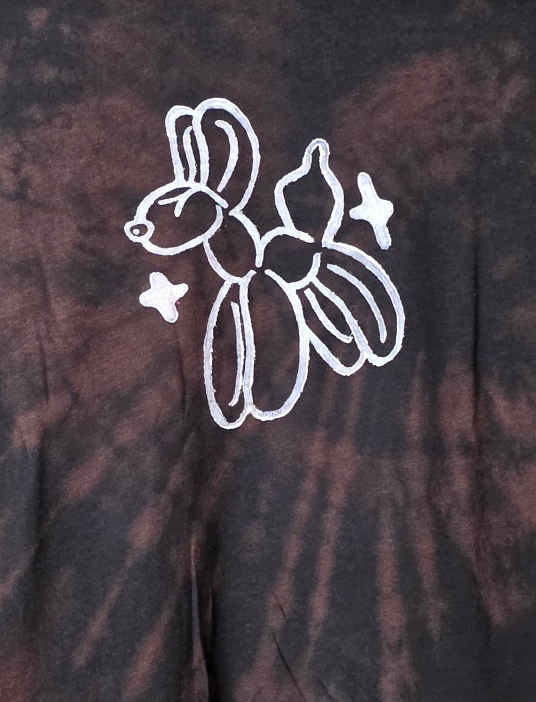 White balloon animal design on a bleach tie-dye background