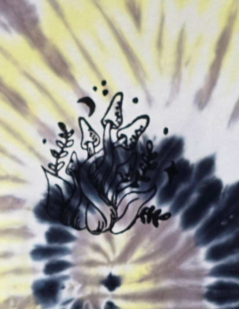 Black mushroom design on a tie-dye background with yellow and black patterns