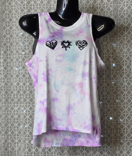 Tie-dye tank top with heart designs on a mannequin against a patterned background