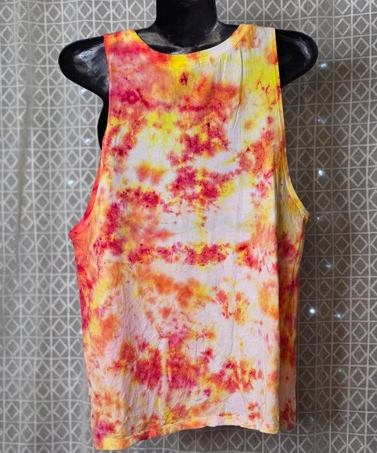 Colorful tie-dye sleeveless top on a mannequin against a patterned wall.