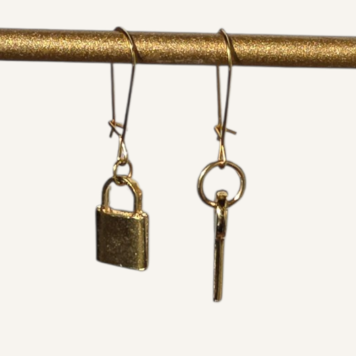 Brass padlock and key on a white background