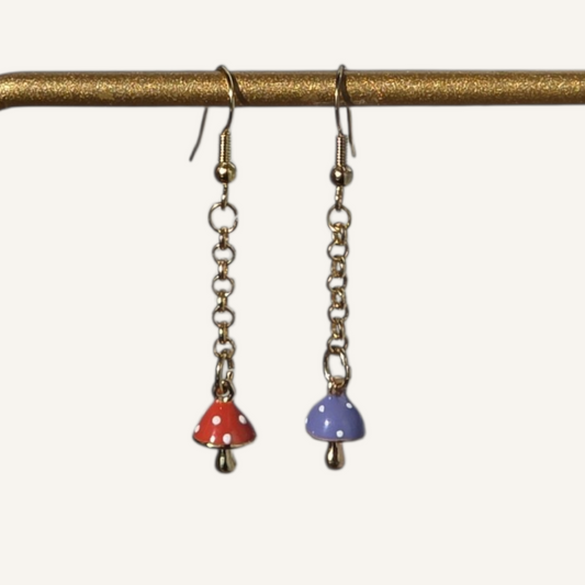Pair of earrings with colorful beads hanging from a brass rod on a white background